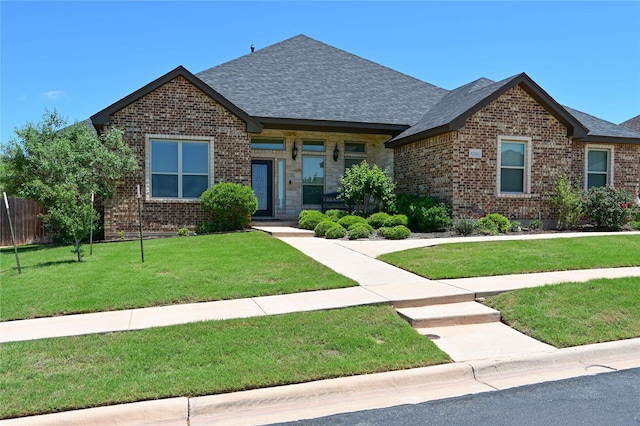 8301 Cimarron Trl, Abilene, TX 79606 - craftsman-style house featuring a front lawn, brick siding, roof with shingles, and fence