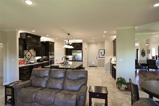 8301 Cimarron Trl, Abilene, TX 79606 - living area with stone tile flooring, crown molding, baseboards, arched walkways, and recessed lighting