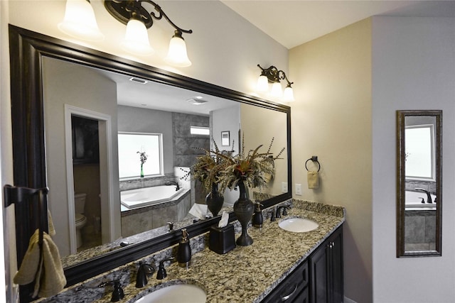 8301 Cimarron Trl, Abilene, TX 79606 - bathroom with toilet, a garden tub, and a sink