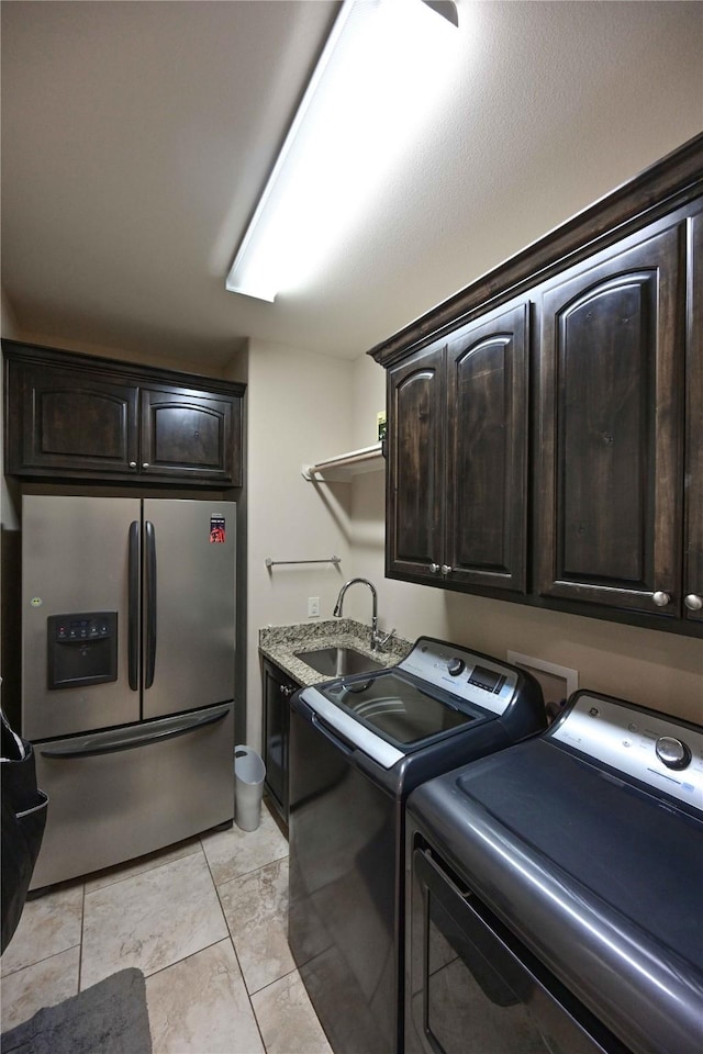 8301 Cimarron Trl, Abilene, TX 79606 - laundry area with a sink, washer and clothes dryer, and cabinet space