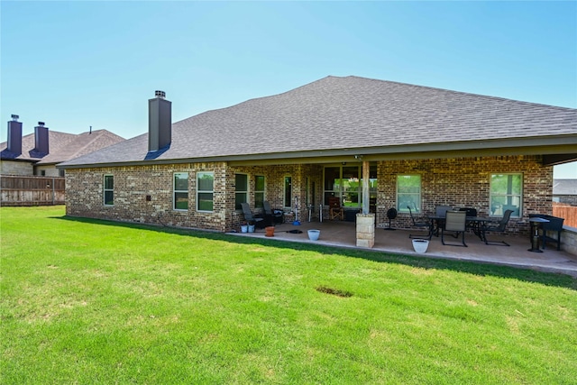 8301 Cimarron Trl, Abilene, TX 79606 - back of house featuring a patio area, fence, brick siding, a yard, and a shingled roof