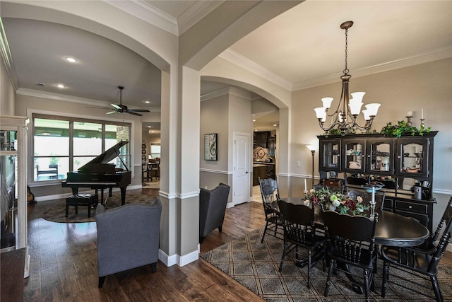 8301 Cimarron Trl, Abilene, TX 79606 - dining room with baseboards, ornamental molding, ceiling fan with notable chandelier, dark wood-type flooring, and arched walkways