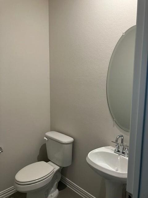 213 Irvin Dr, Royse City, TX 75189 - bathroom with toilet, a sink, and baseboards