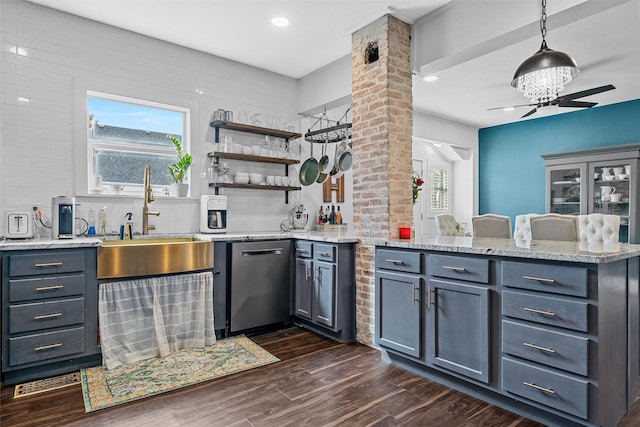 kitchen featuring a sink, a peninsula, light stone counters, and dishwasher