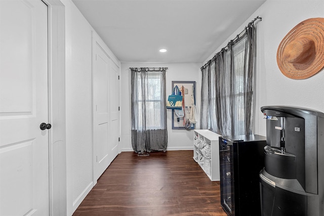 interior space featuring wood finished floors, baseboards, wine cooler, and recessed lighting