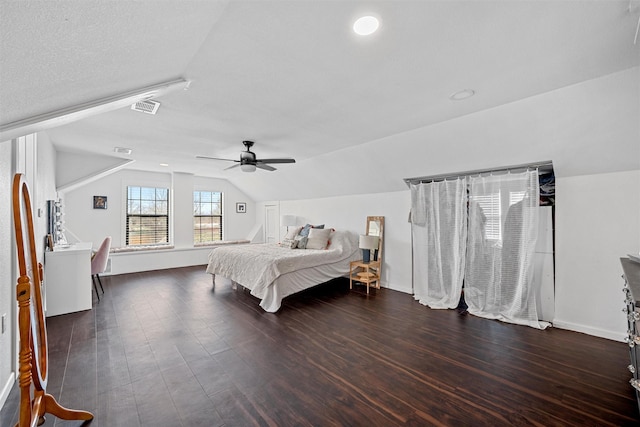 bedroom featuring visible vents, wood finished floors, lofted ceiling, and ceiling fan