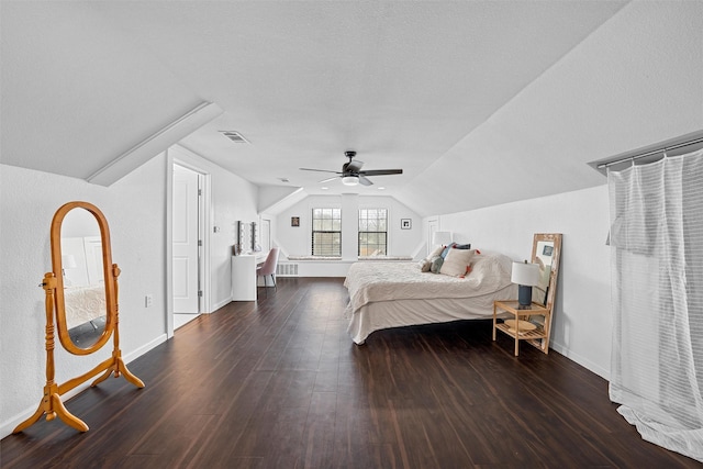 bedroom featuring wood finished floors, visible vents, baseboards, ceiling fan, and vaulted ceiling