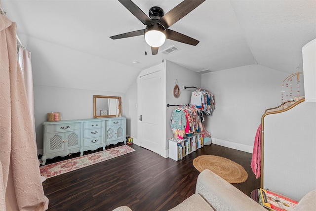 interior space with lofted ceiling, wood finished floors, visible vents, a ceiling fan, and baseboards
