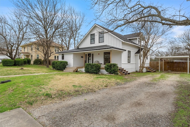 bungalow-style home with covered porch, dirt driveway, fence, board and batten siding, and a front yard