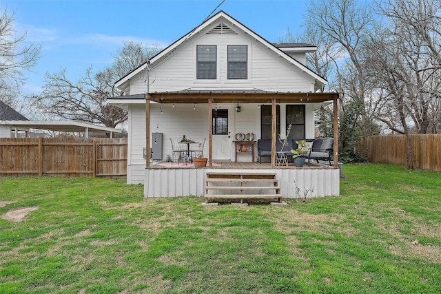 back of house featuring a fenced backyard, a wooden deck, and a lawn