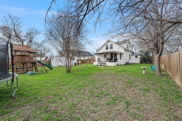 view of yard with a fenced backyard, a trampoline, central air condition unit, and a playground