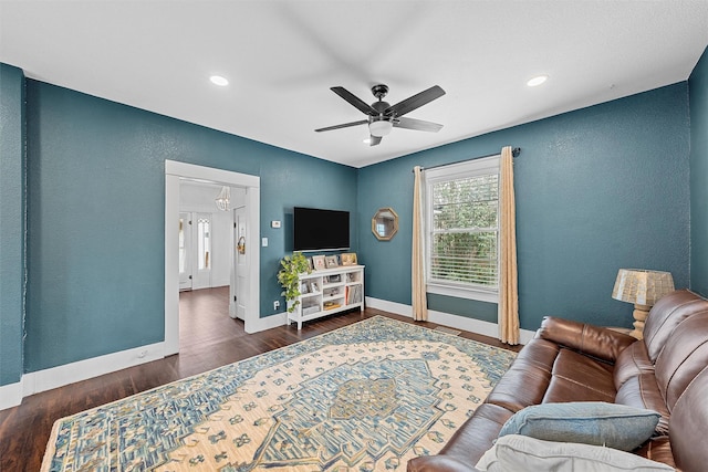 living area featuring recessed lighting, baseboards, ceiling fan, wood finished floors, and a textured wall