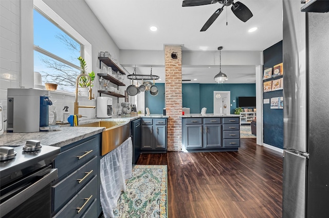 kitchen with a ceiling fan, a sink, freestanding refrigerator, open shelves, and dark wood finished floors