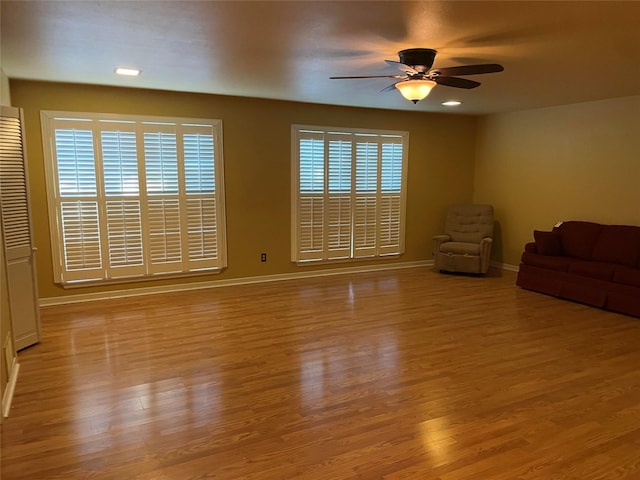 unfurnished living room featuring light wood-style flooring, baseboards, a ceiling fan, and recessed lighting