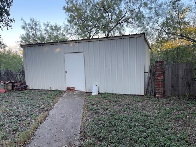 view of outbuilding with an outbuilding and fence