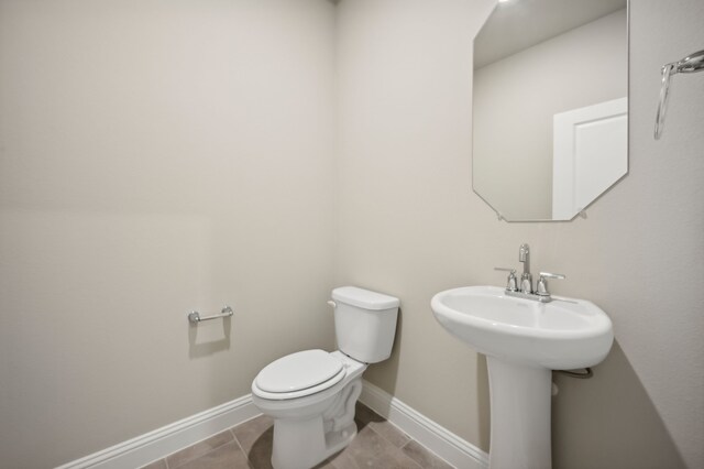 604 Willet Dr, Mckinney, TX 75069 - half bath featuring toilet, baseboards, and tile patterned flooring
