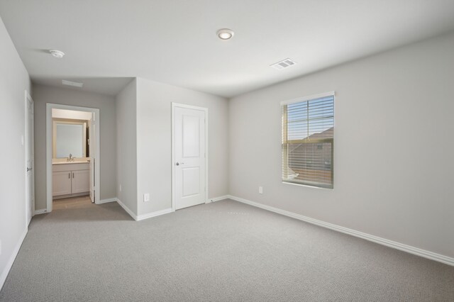 604 Willet Dr, Mckinney, TX 75069 - unfurnished bedroom with a sink, carpet floors, baseboards, and visible vents