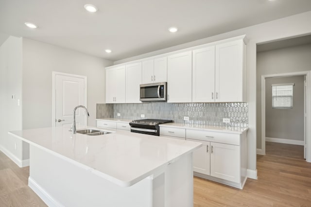 604 Willet Dr, Mckinney, TX 75069 - kitchen with stainless steel appliances, a sink, light wood finished floors, an island with sink, and recessed lighting