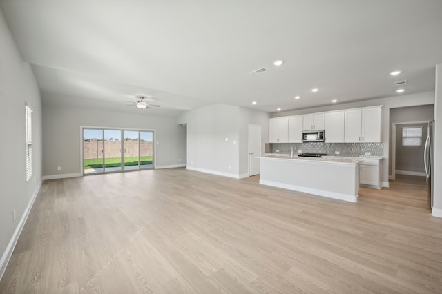 604 Willet Dr, Mckinney, TX 75069 - unfurnished living room with light wood finished floors, baseboards, a ceiling fan, and recessed lighting