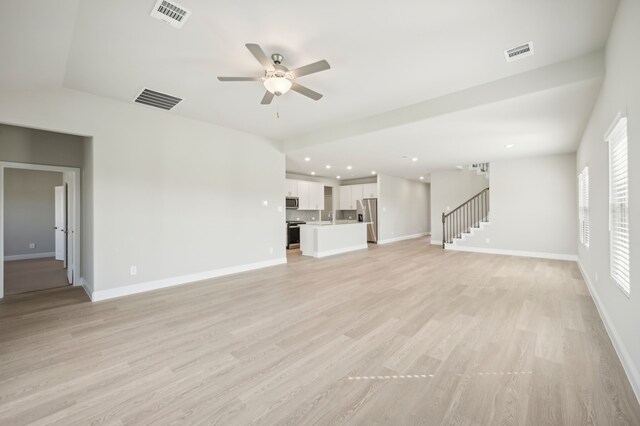 604 Willet Dr, Mckinney, TX 75069 - unfurnished living room with ceiling fan, stairs, and visible vents