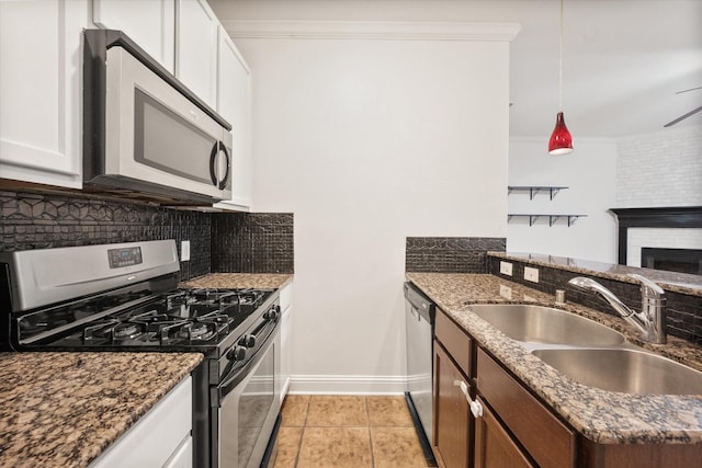 13336 Patito Pl Unit 7, Dallas, TX 75240 - kitchen with a sink, stainless steel appliances, tasteful backsplash, dark stone countertops, and baseboards