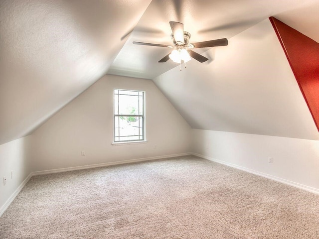 bonus room with lofted ceiling, baseboards, a ceiling fan, and carpet floors