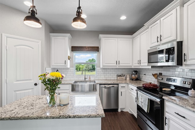 6093 S Fm 730, Decatur, TX 76234 - kitchen featuring stainless steel appliances, a sink, white cabinets, dark wood-style floors, and tasteful backsplash