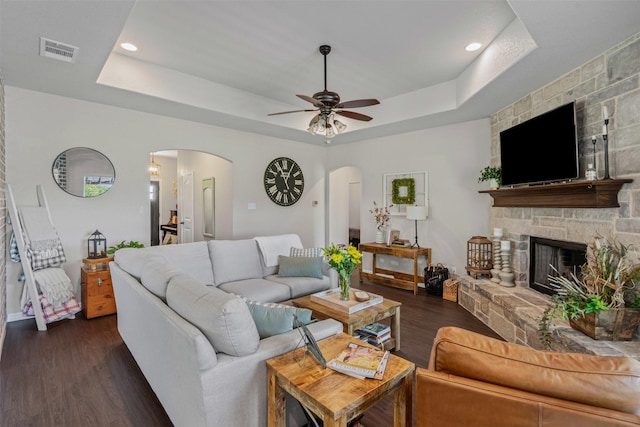 6093 S Fm 730, Decatur, TX 76234 - living room featuring arched walkways, a raised ceiling, dark wood-style flooring, a ceiling fan, and recessed lighting