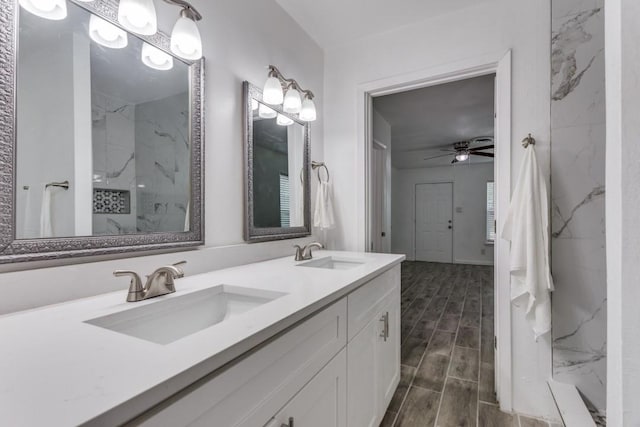 bathroom featuring a sink, ceiling fan, wood finish floors, and a marble finish shower
