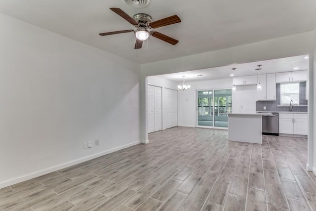 unfurnished living room featuring recessed lighting, baseboards, visible vents, ceiling fan with notable chandelier, and light wood-style floors