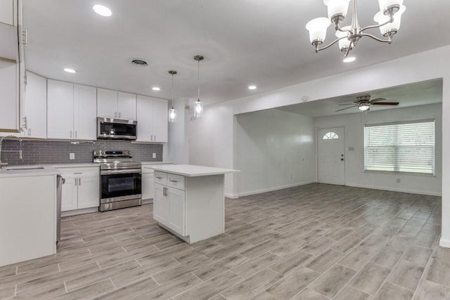 kitchen featuring a sink, stainless steel appliances, light countertops, tasteful backsplash, and recessed lighting