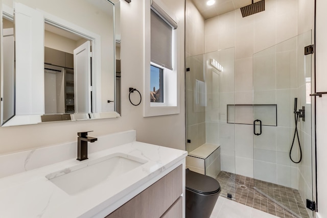 full bathroom featuring vanity, toilet, and a shower stall