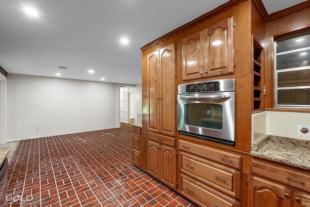 5764 Jefferson Paige Rd, Shreveport, LA 71119 - kitchen featuring stainless steel oven, brick patterned floors, recessed lighting, light stone counters, and brown cabinets