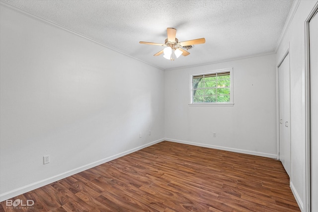 unfurnished bedroom with crown molding, a textured ceiling, and wood finished floors