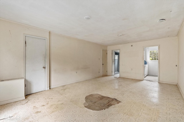 unfurnished room featuring baseboards