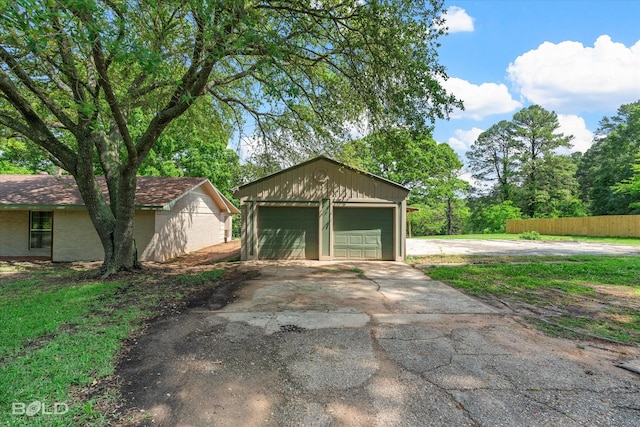 detached garage featuring fence