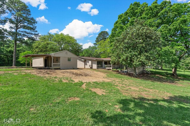 back of property featuring a lawn