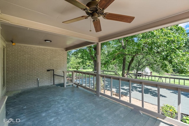 5764 Jefferson Paige Rd, Shreveport, LA 71119 - view of wooden balcony featuring a deck, ceiling fan, and view of scattered trees