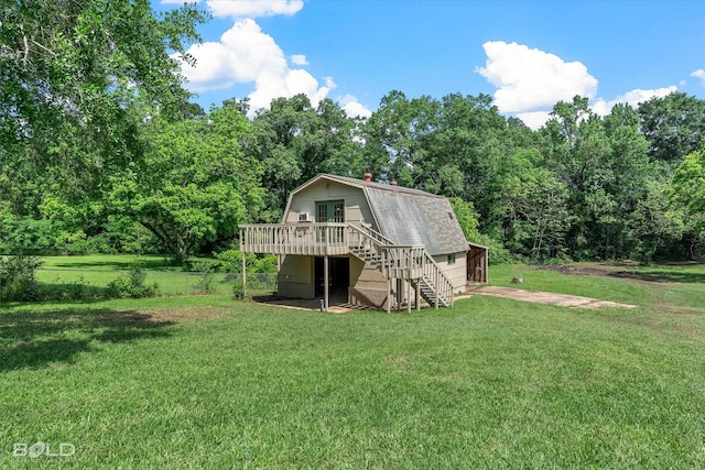 back of property with a lawn, stairs, a gambrel roof, and a deck