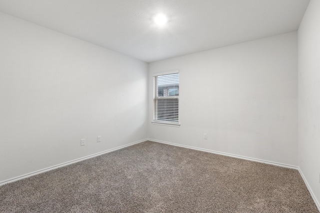 empty room with carpet flooring and baseboards