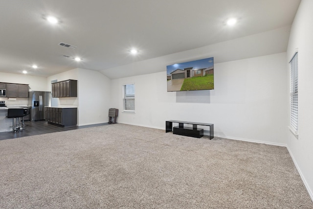 unfurnished living room featuring baseboards, recessed lighting, dark colored carpet, and visible vents
