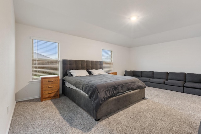 bedroom with light carpet and baseboards