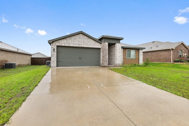 ranch-style house with fence, an attached garage, brick siding, driveway, and a front yard