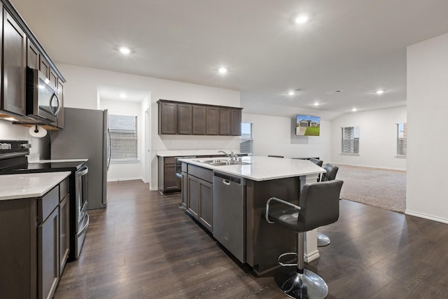 kitchen with open floor plan, light countertops, baseboards, and appliances with stainless steel finishes