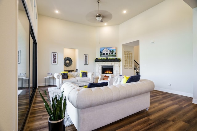915 Blueberry Way, Northlake, TX 76247 - living room with a ceiling fan, a fireplace, dark wood-type flooring, baseboards, and stairs