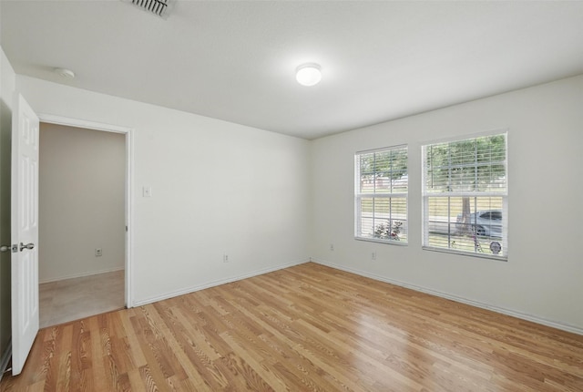3105 Lipizzan Dr, Denton, TX 76210 - unfurnished room with light wood finished floors, baseboards, and a smoke detector