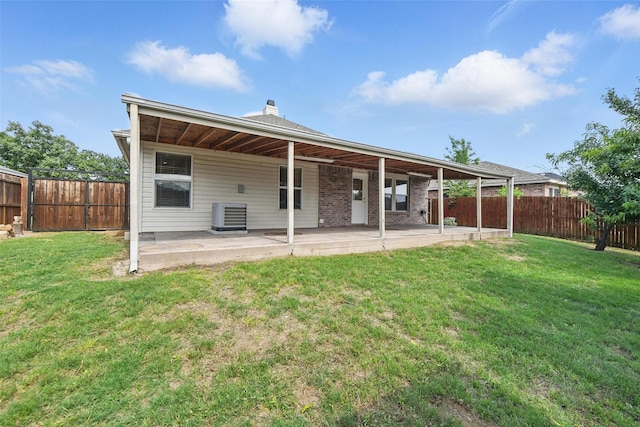 3105 Lipizzan Dr, Denton, TX 76210 - rear view of house with a patio area, cooling unit, and a chimney