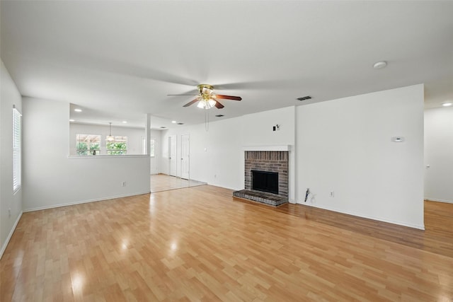 3105 Lipizzan Dr, Denton, TX 76210 - unfurnished living room with light wood-type flooring, a ceiling fan, recessed lighting, a fireplace, and baseboards