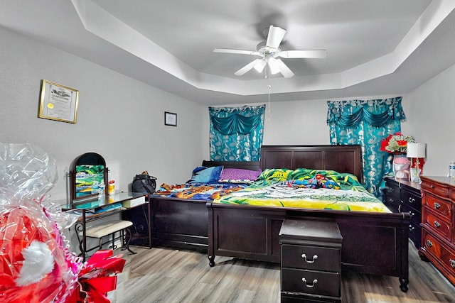 600 Saint Luke St, Terrell, TX 75160 - bedroom with a ceiling fan, wood finished floors, and a raised ceiling