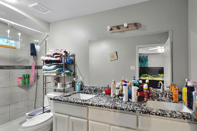 600 Saint Luke St, Terrell, TX 75160 - full bathroom with toilet, vanity, visible vents, ceiling fan, and tiled shower